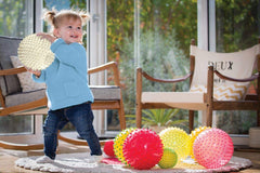 Edushape sensory ball with textured surface and bright colors invites tactile play.