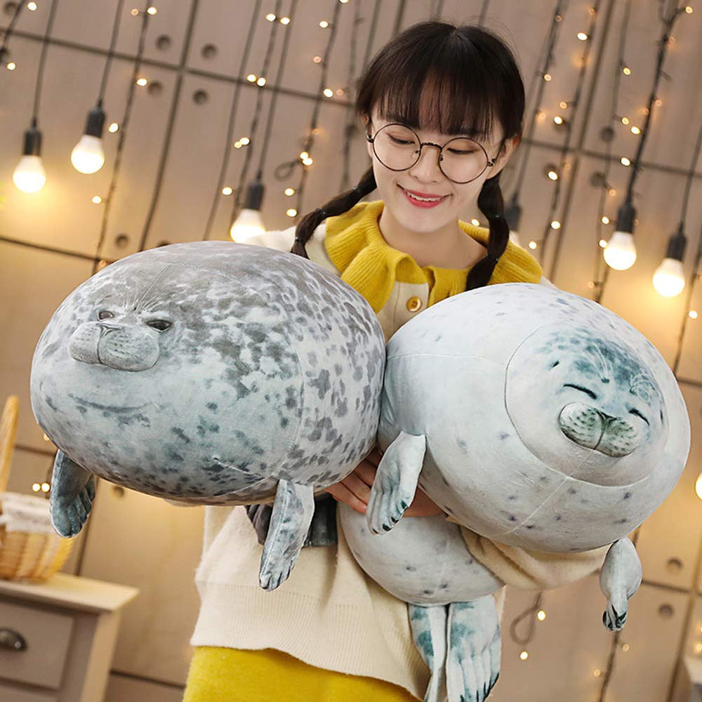EHOTONG 60 cm seal pillow placed on a living room couch for cozy decor.