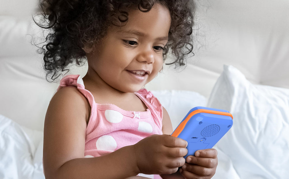 eKids Blippi toy phone held by a child for portable learning on the go