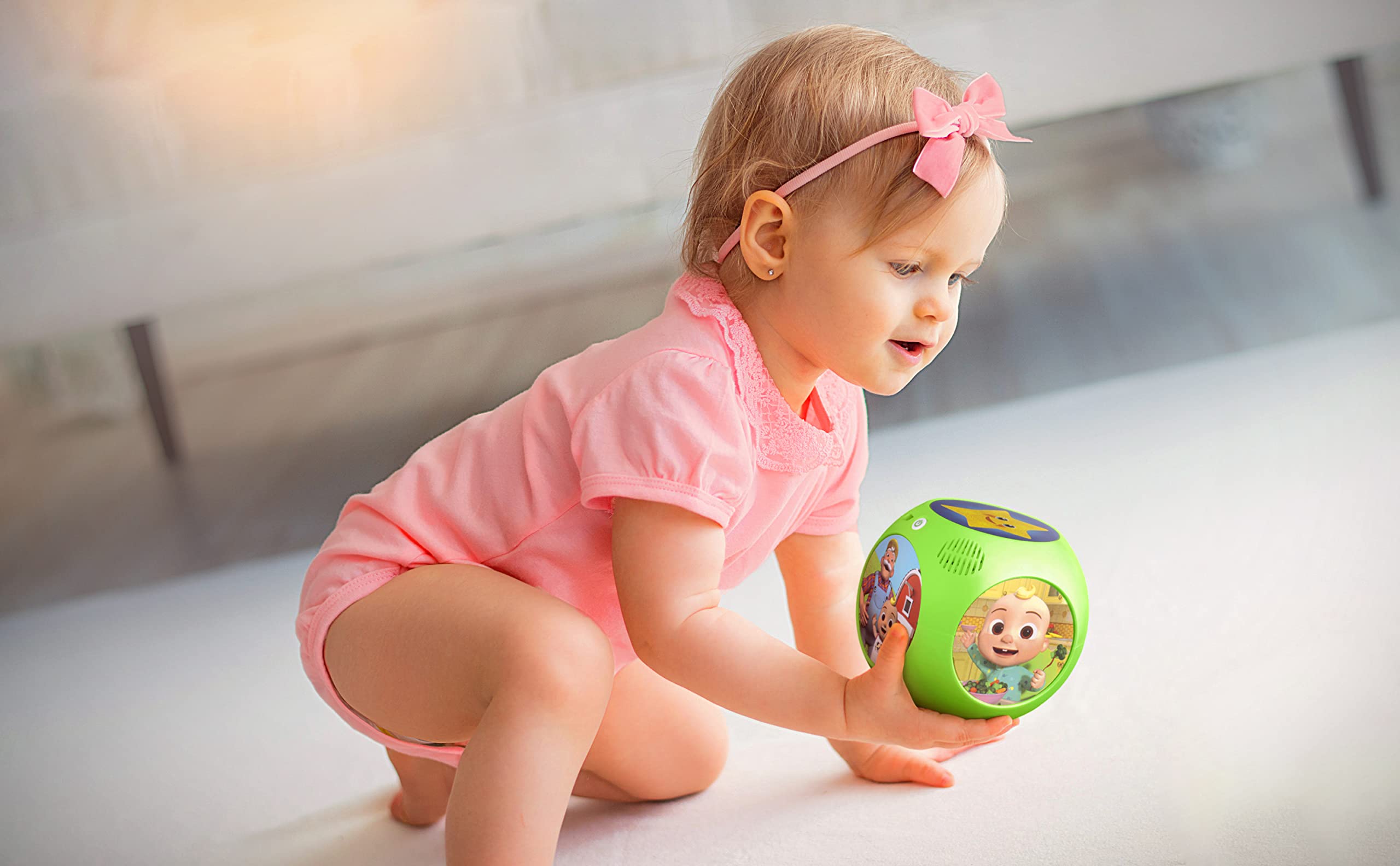 ekids Cocomelon musical toy rotated to reveal six nursery rhymes.