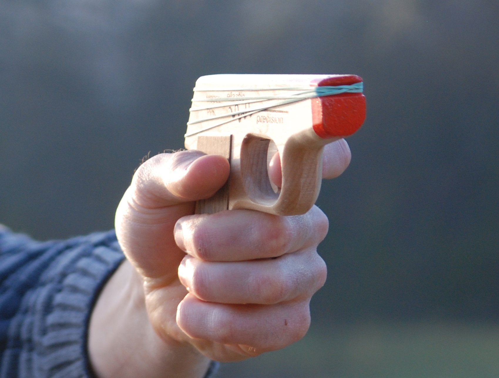 Elastic Precision PPK with walnut grips offers secure, comfortable handling.
