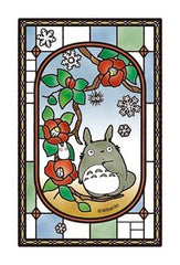 Ensky Blooming Camellia puzzle display with stained-glass-like glow on windows.