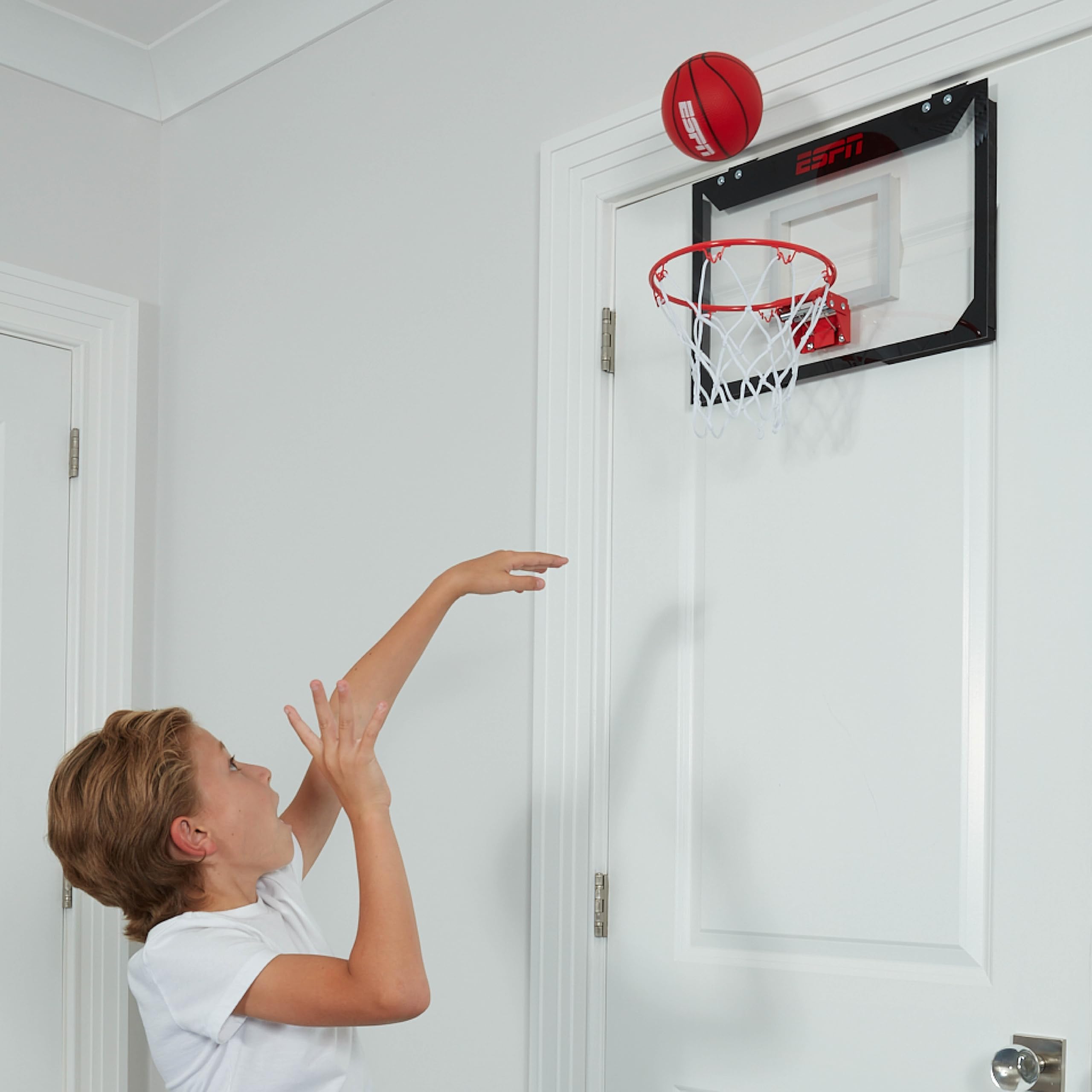 Family game night using ESPN hoop in living room.