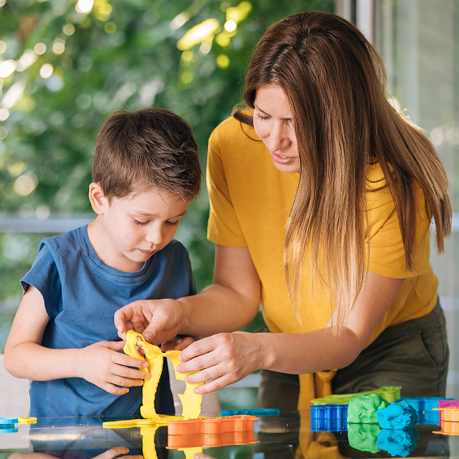 Essenson kids crafting session shows imaginative play with clay.
