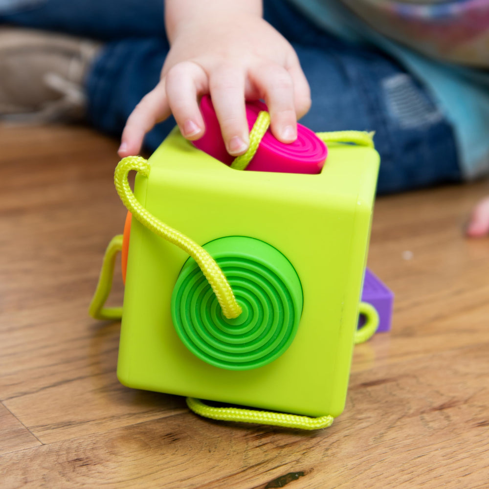OombeeCube rubbery textures support tactile learning and teething.