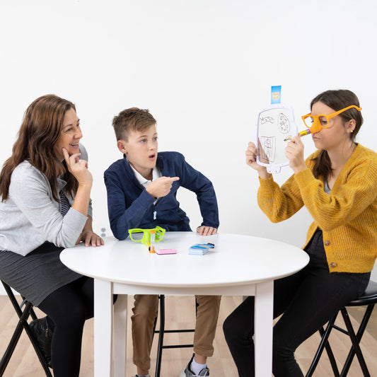 Fat Brain Toys Pencil Nose drawing action captures players guessing with fun, fast-paced party energy.