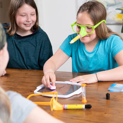 Fat Brain Toys Pencil Nose family night scene showcases inclusive fun for 4 players and up.
