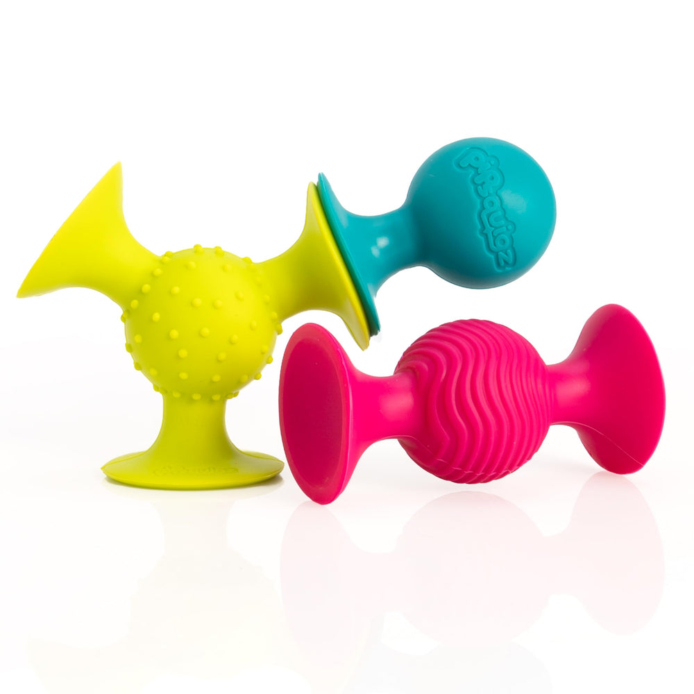 Fat Brain Toys pipSquigz suction cup rattle attached to a surface for baby play