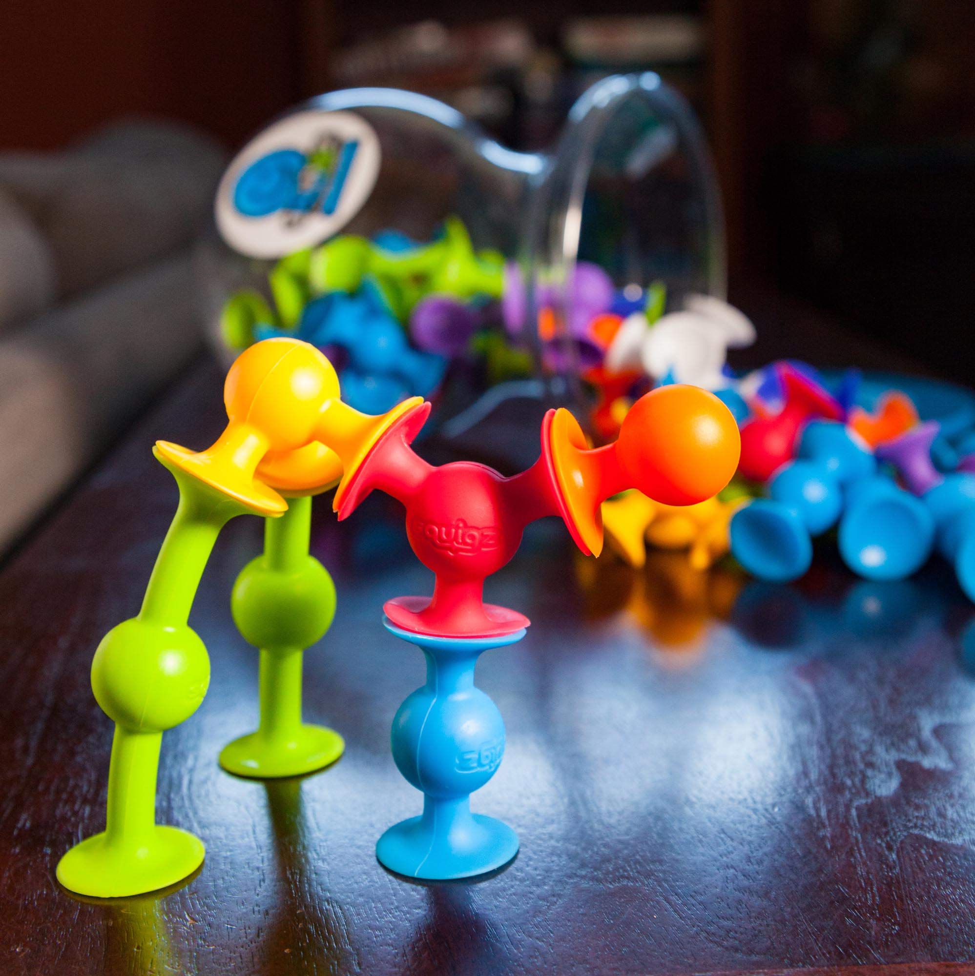 Fat Brain Toys Squigz Deluxe Set during bath time supports sensory exploration safely.