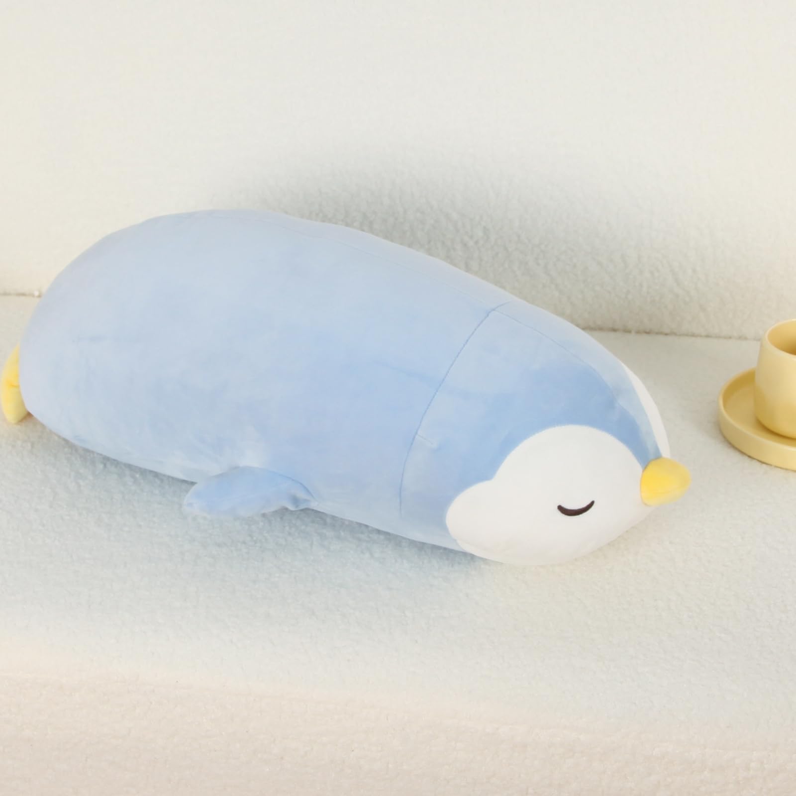 FFxiong 22-inch penguin plush as a body pillow for relaxed lounging