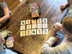 Family night setup with FIRST TO WORST Care Bears visuals and cards.