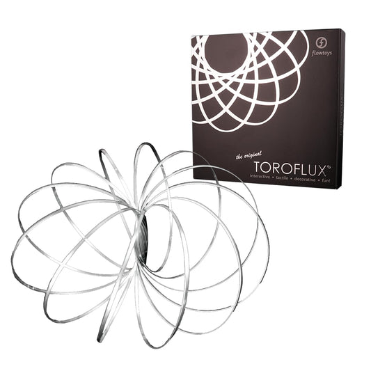 Flowtoys Toroflux on table; mesmerizing kinetic sculpture for hands-on learning.