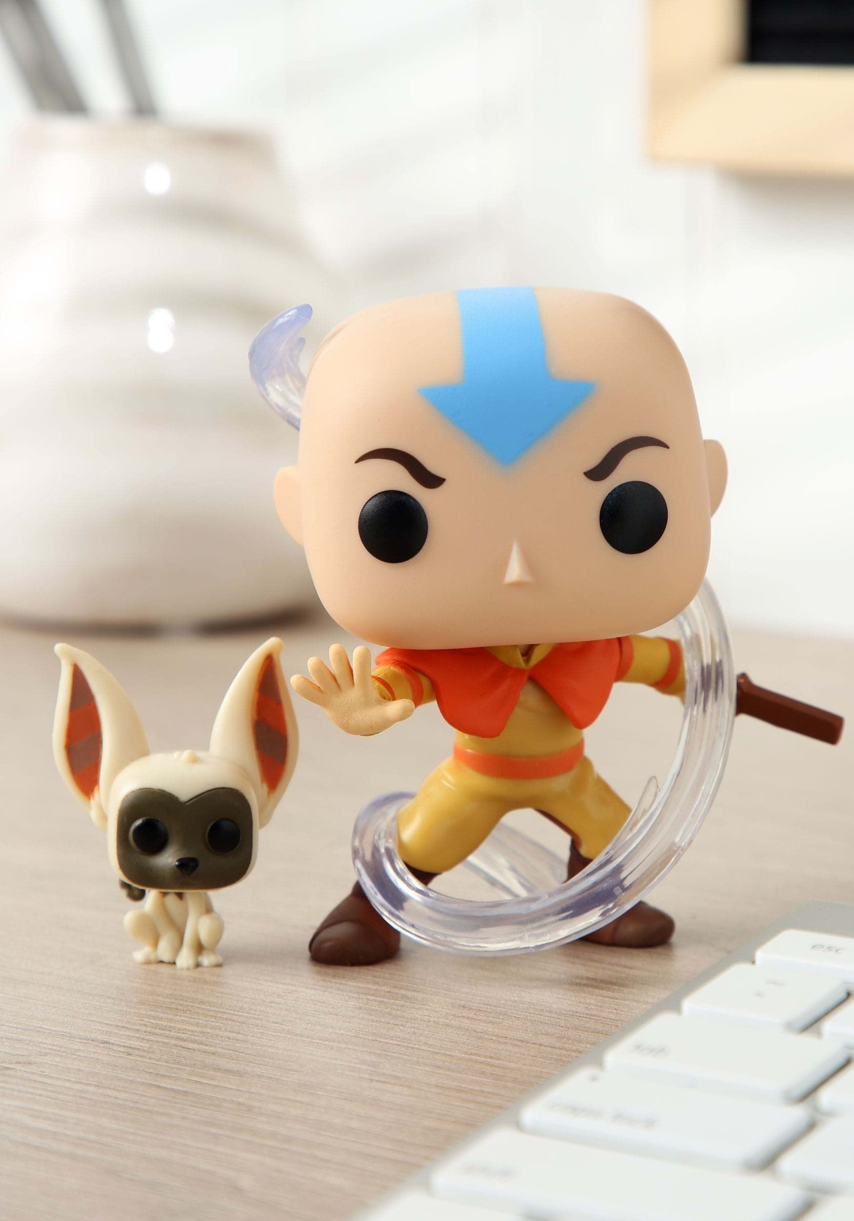 Funko Avatar Aang with Momo Pop Vinyl on display shelf boosts collection appeal.