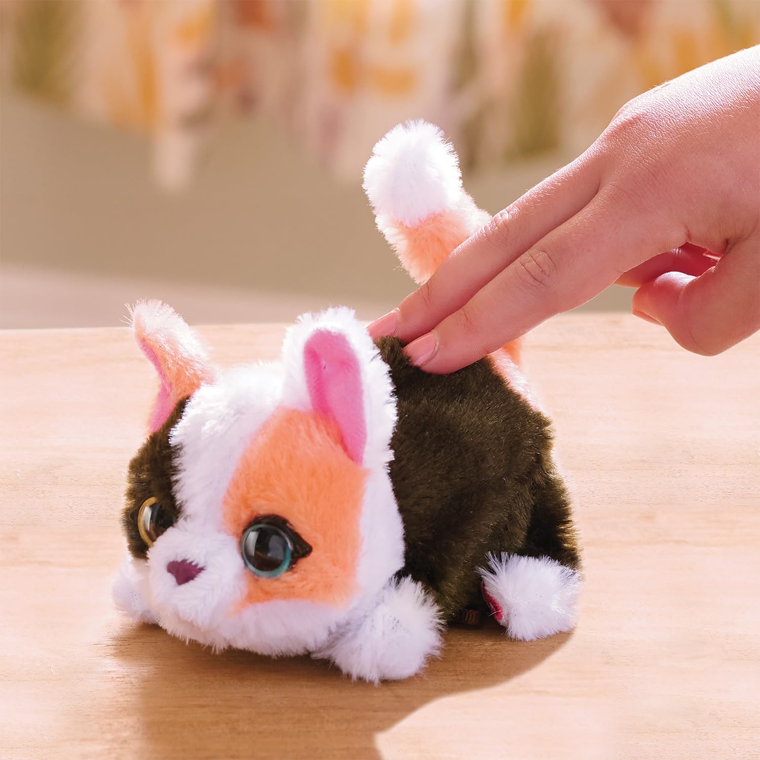 FurReal My Minis kitty back detail with hand pat demonstration, shows motion activation benefit