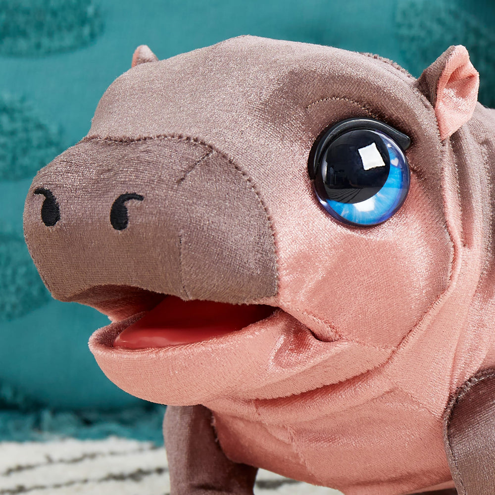 FurReal Sally held in child's hands, showing compact 9-inch size for easy carry