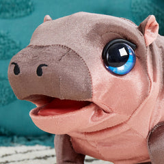 FurReal Sally held in child's hands, showing compact 9-inch size for easy carry