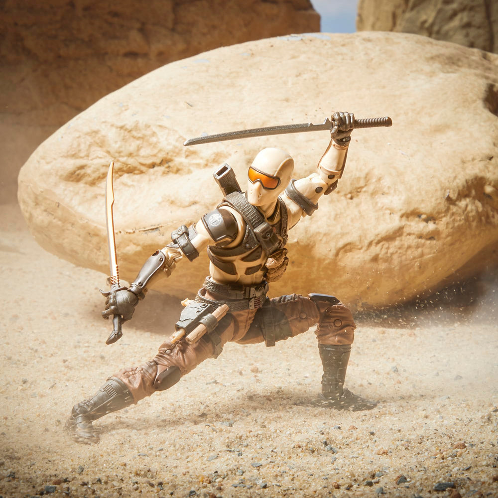 G.I. Joe Desert Commando Snake Eyes suppressor accessory on left weapon.