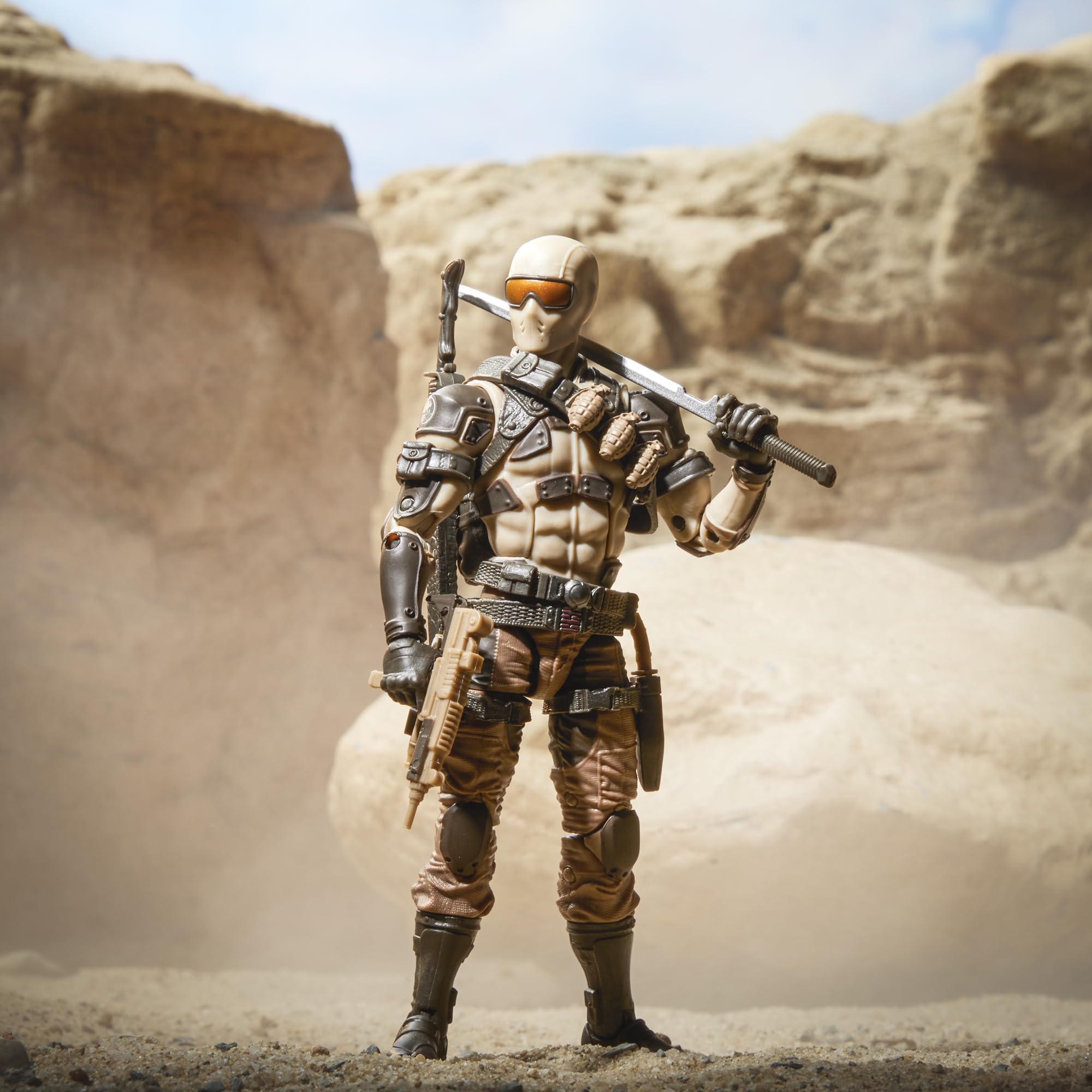 G.I. Joe Desert Commando Snake Eyes suppressor accessory on right weapon.