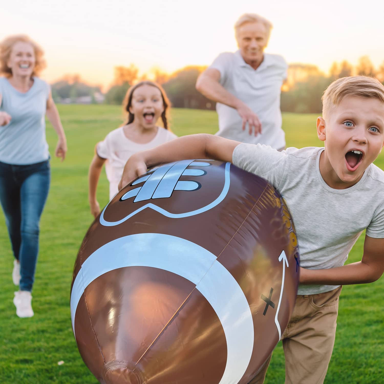 GiftExpress inflatable football with tee set up for backyard games.