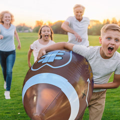 GiftExpress inflatable football with tee set up for backyard games.