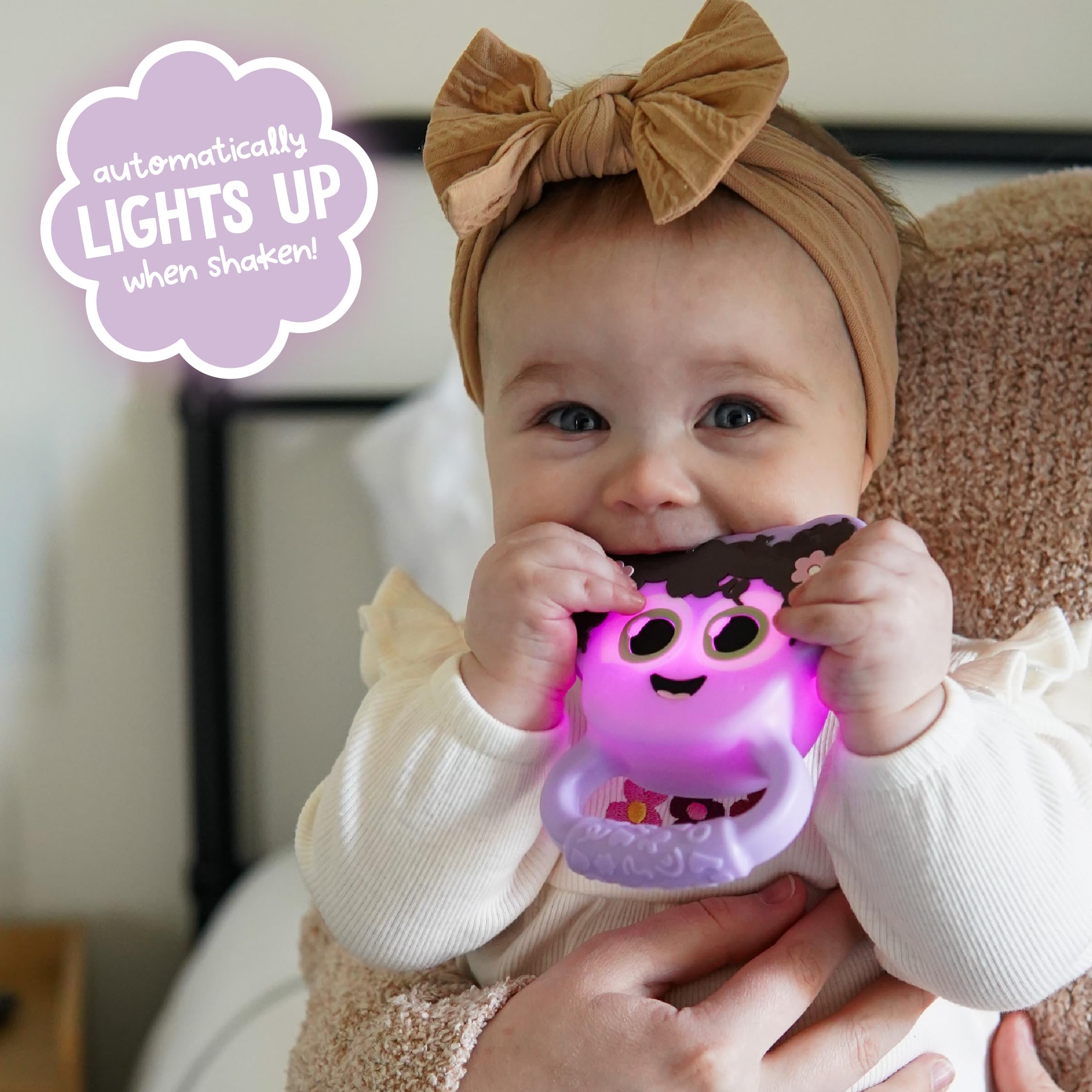 Glo Pals Light-Up Rattle side grip encourages grasp and bilateral movement.