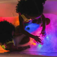Glo Pals cubes illuminated in water demonstrate cause-and-effect during play.