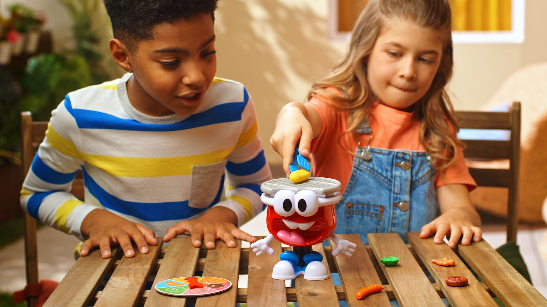 Goliath BBQ Party Game tongs in hand invites hands-on play.