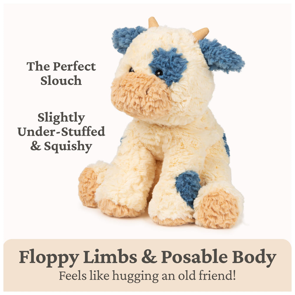 GUND Cozys Cow plush shows beige horns and a navy tail tuft for detail.