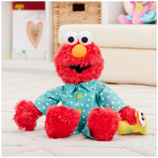GUND Elmo wearing blue polka-dot pajamas glows, ideal for playful nightlight moments.
