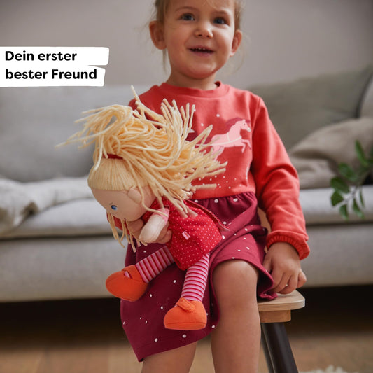 HABA Annelie doll with removable red dress for easy dressing practice