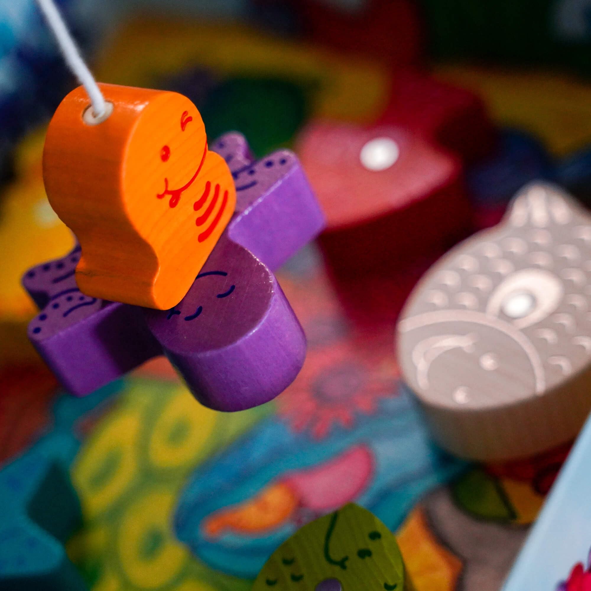 HABA Here Fishy Fishy magnetic fishing game dice-roll scene introduces simple rules.
