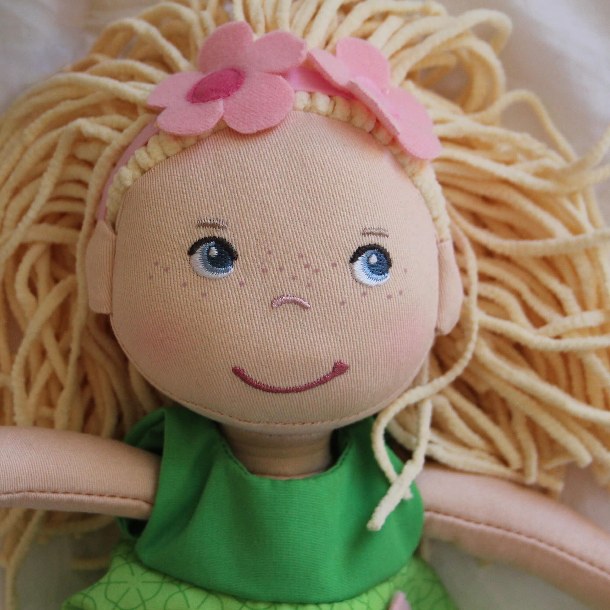 Mali doll wearing a removable green dress with leggings and accessories for mix-and-match pretend play.