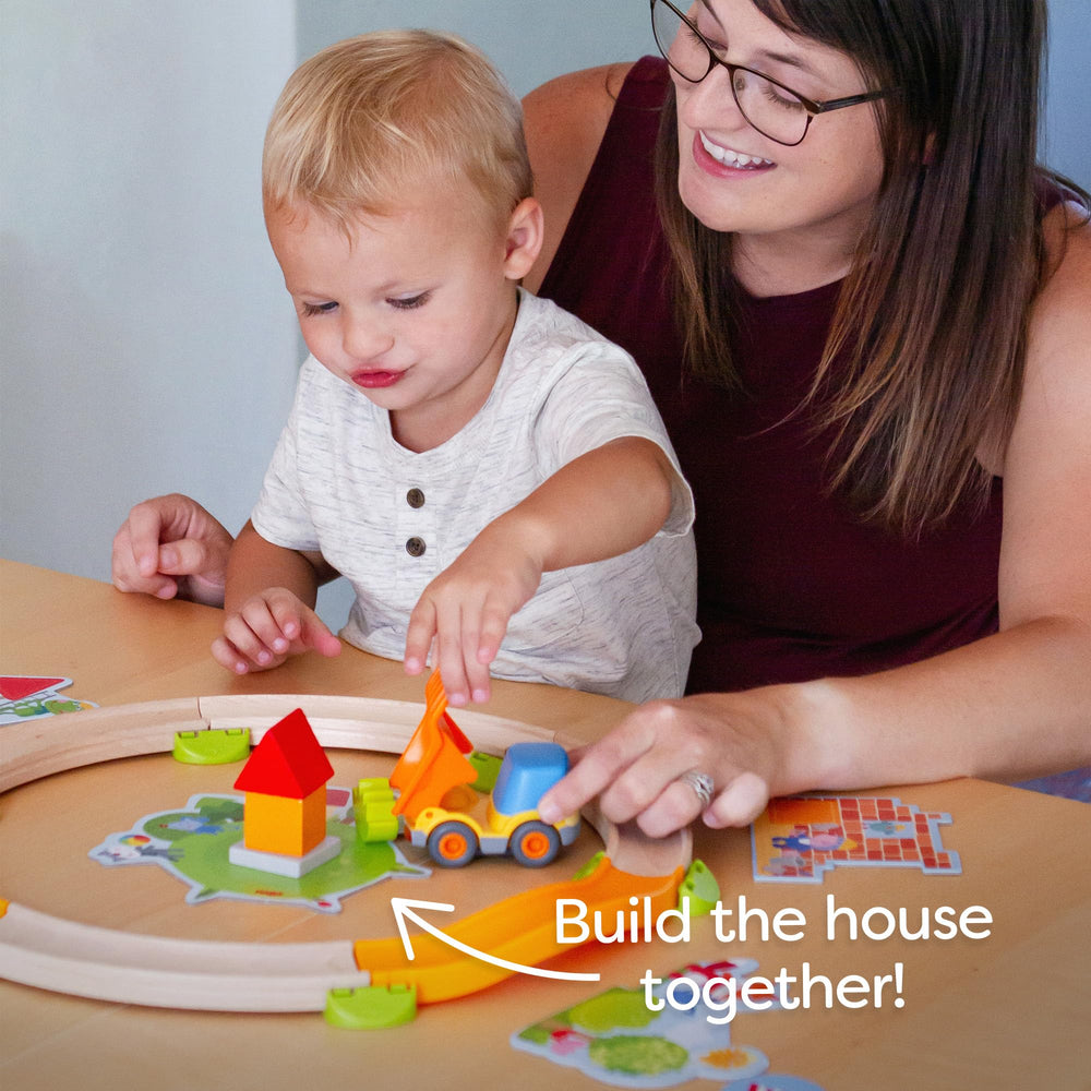 Colorful building pieces and board guide a collaborative construction activity