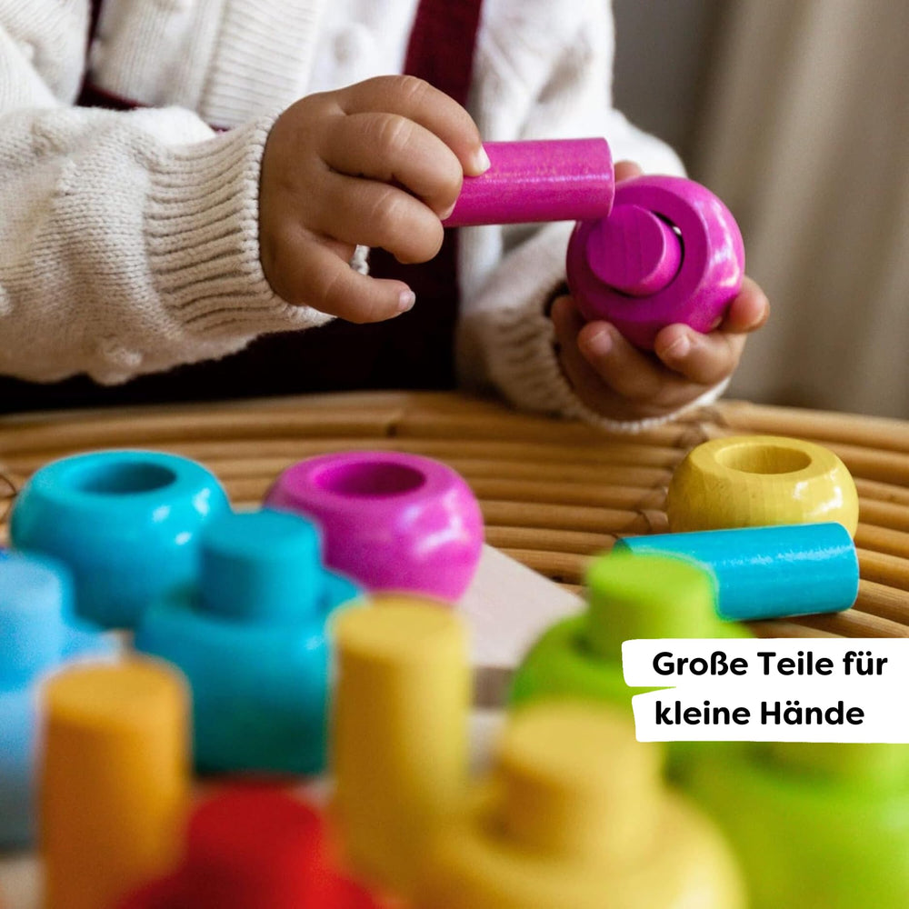 HABA Rainbow Whirls color-sorting play, kids match rings by color for cognitive practice.