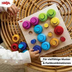 HABA Rainbow Whirls tower-building scene, encourages stacking and imaginative construction.