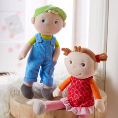HABA Snug Up Till shows blue eyes and cap for imaginative play.