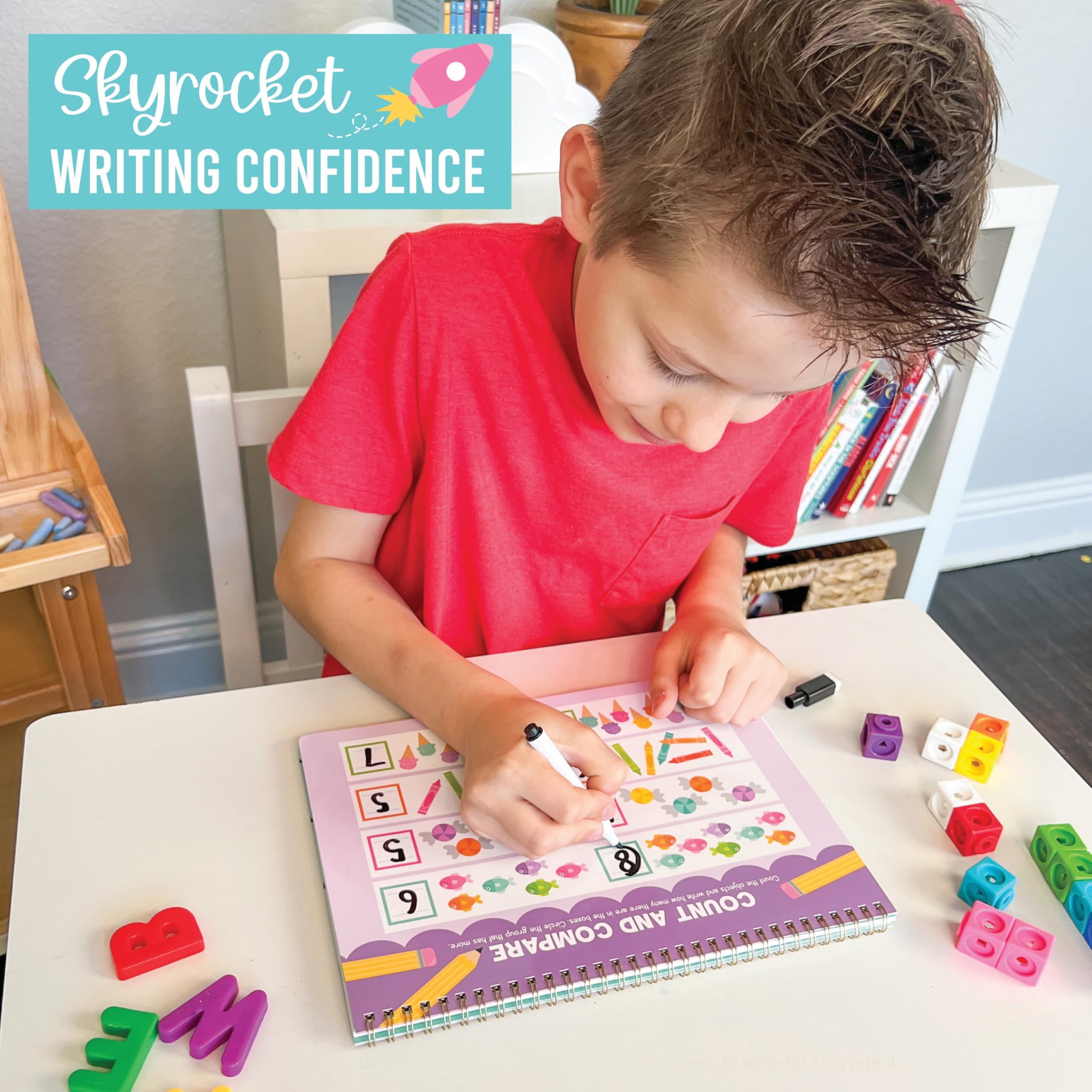 Child practicing tracing with Hadley Designs ABC Tracing Book in a cozy learning corner