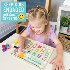 Young learner tracing letters with Hadley Designs book to boost fine motor skills
