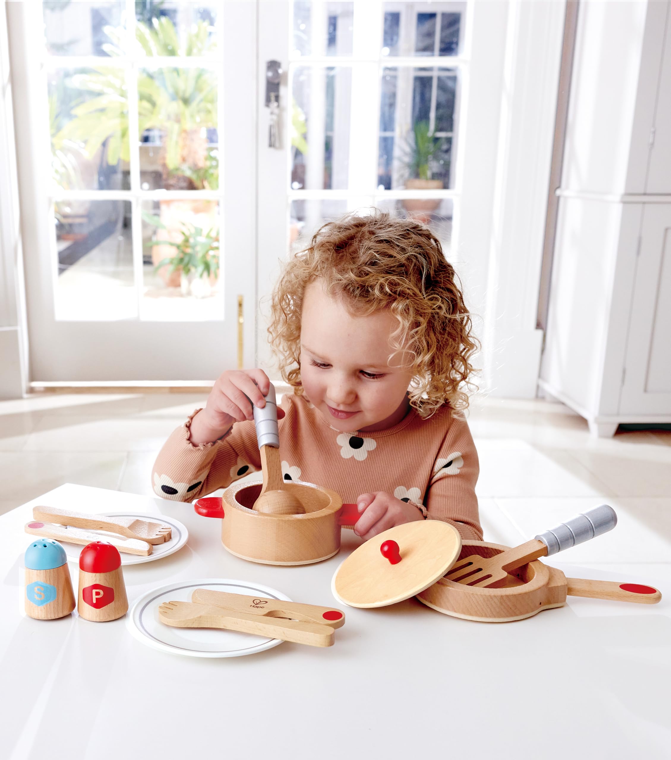 Hape Cook and Serve Set wooden pan supports realistic kitchen role play.