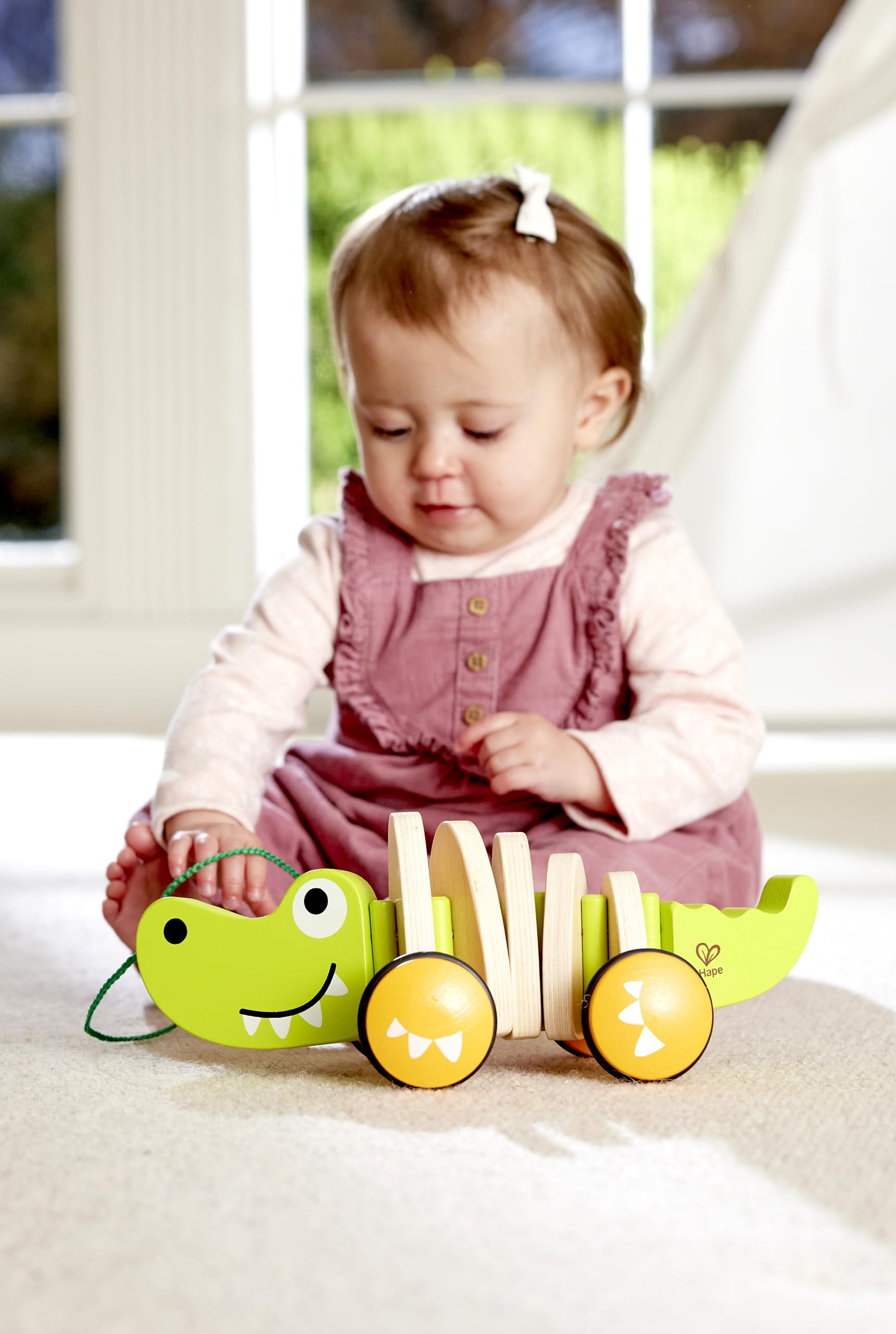Hape pull-and-push croc toy supports pretend play and mobility.