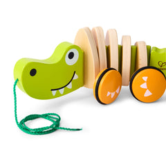 Hape wooden croc toy with color-rich finish sparks imaginative walks.