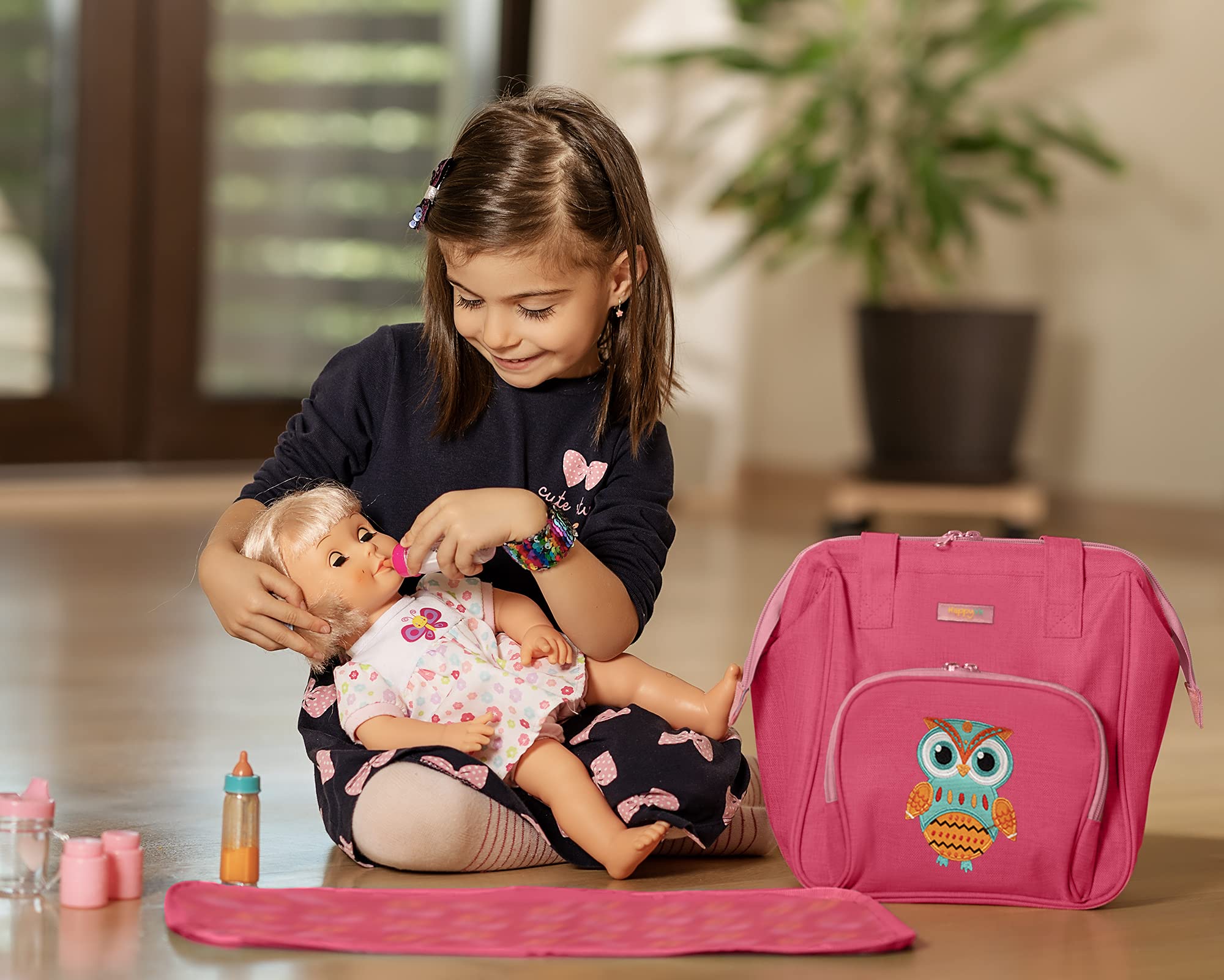 HappyVk child playing with the doll diaper bag during pretend play