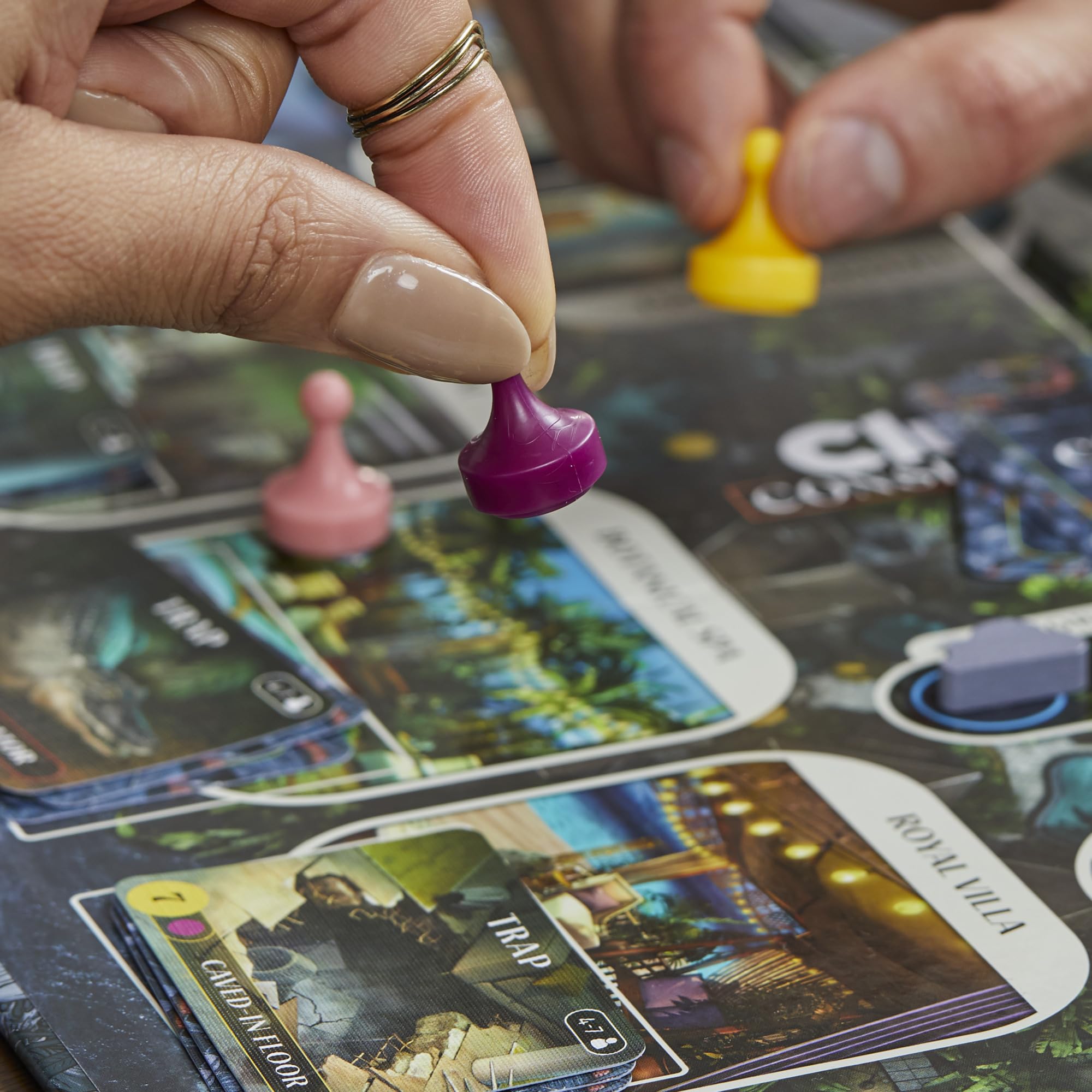 Hasbro Clue Conspiracy in-app QR enhances setup with timers and tutorials.