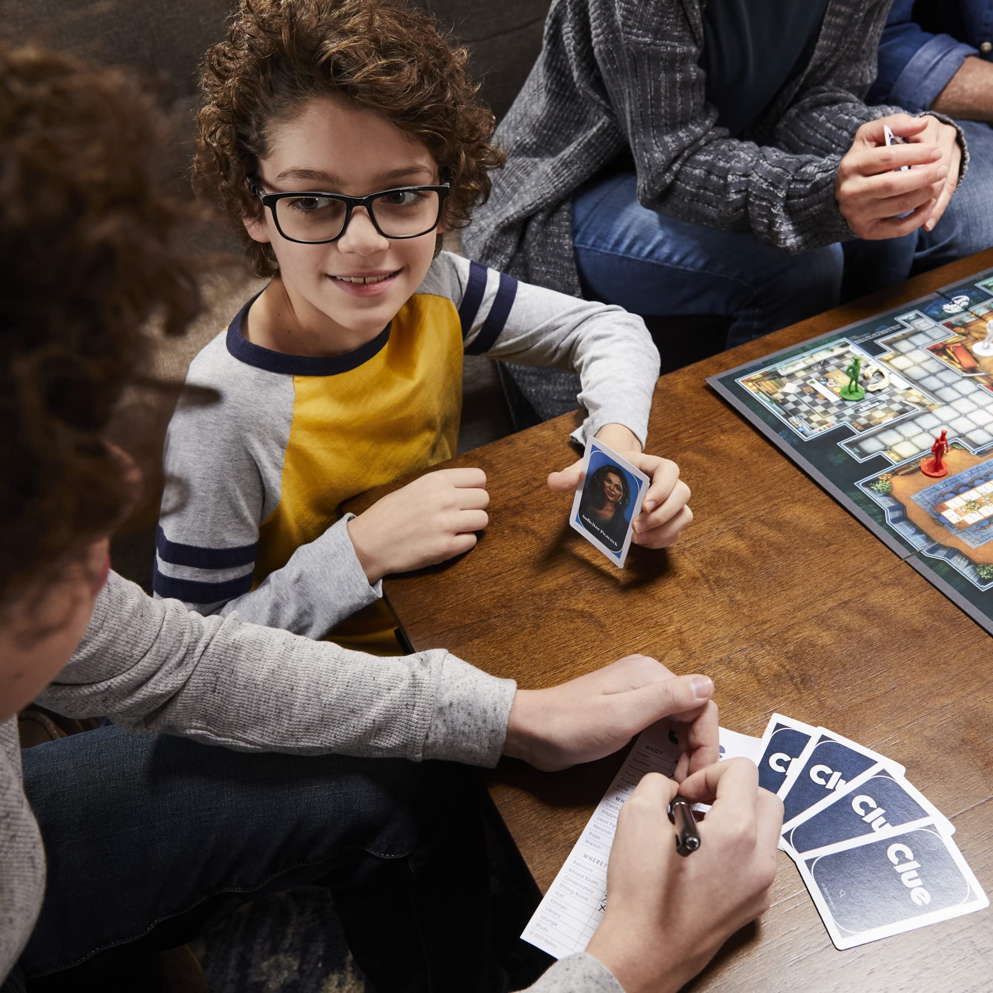 Hasbro Gaming Clue illustrated board showcases glamorous setting.