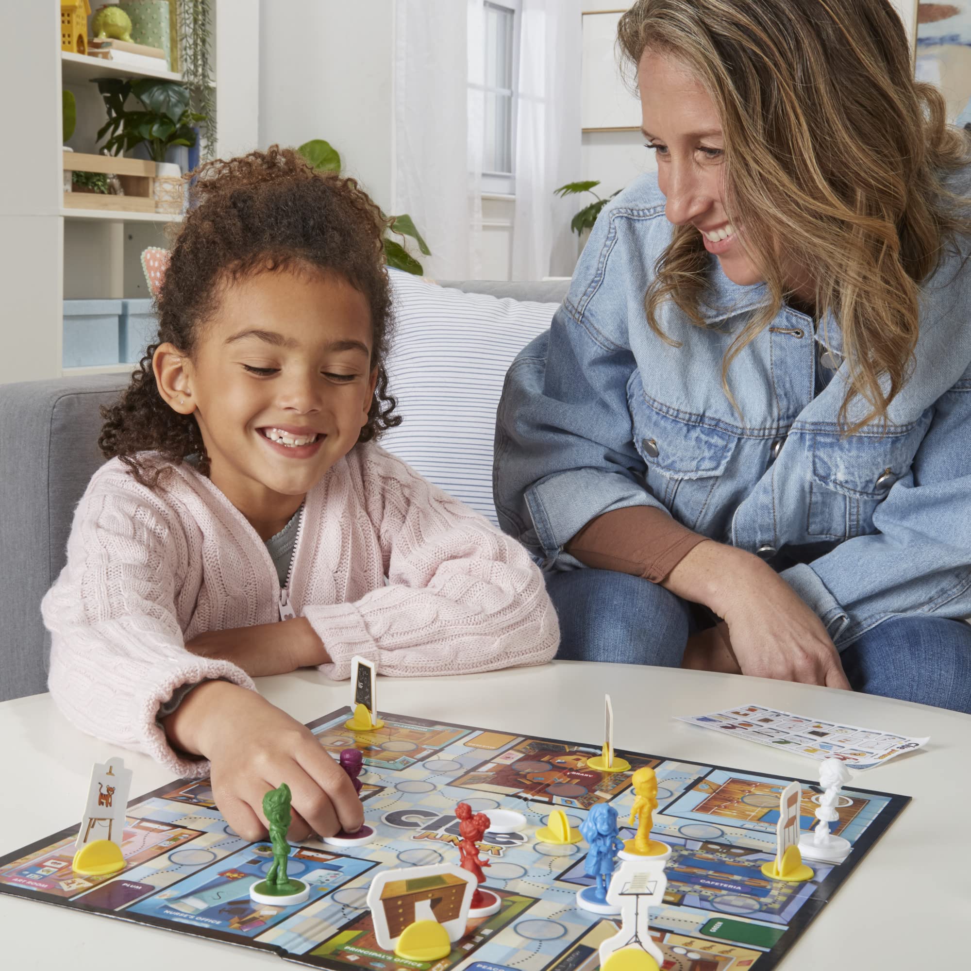 Hasbro Gaming Clue Junior seek-and-find tiles showcase visual clues that spark observation.
