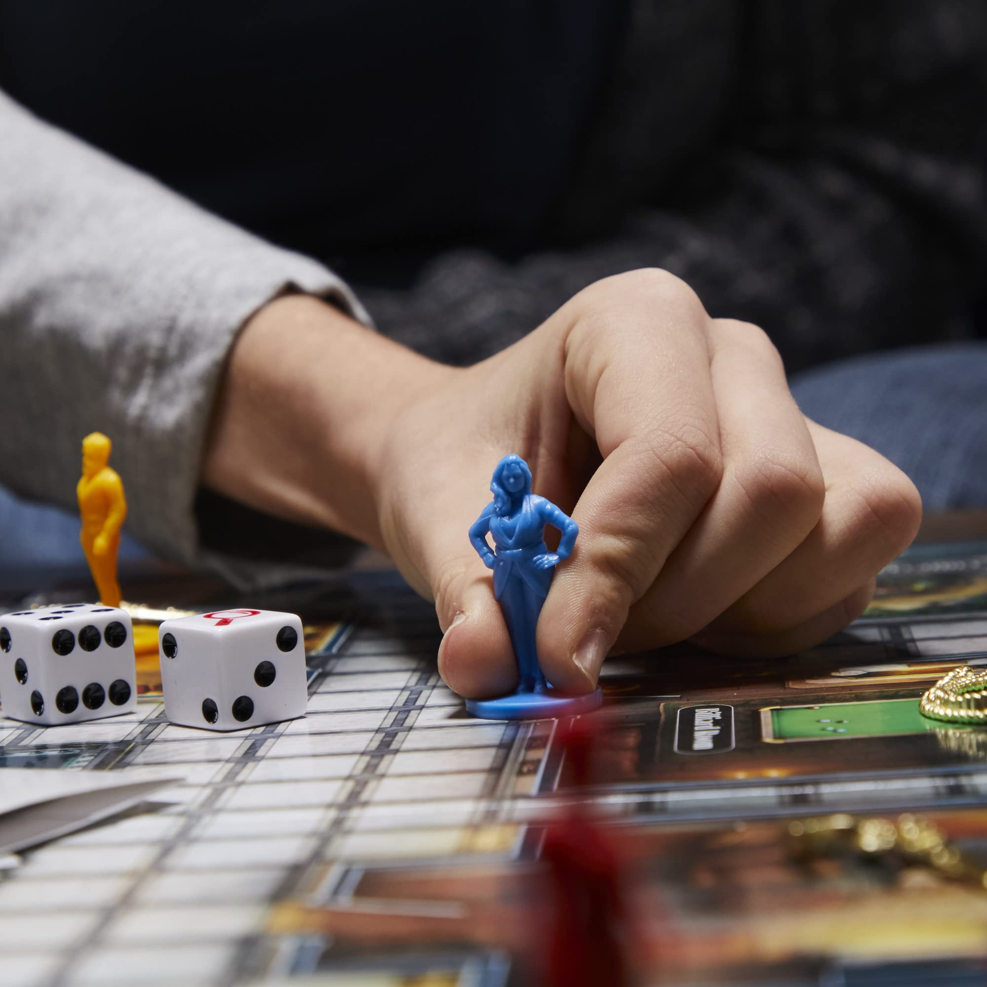 Hasbro Gaming Clue magnifying glass enhances clue discovery.