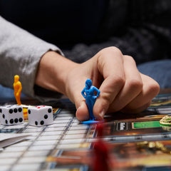 Hasbro Gaming Clue magnifying glass enhances clue discovery.