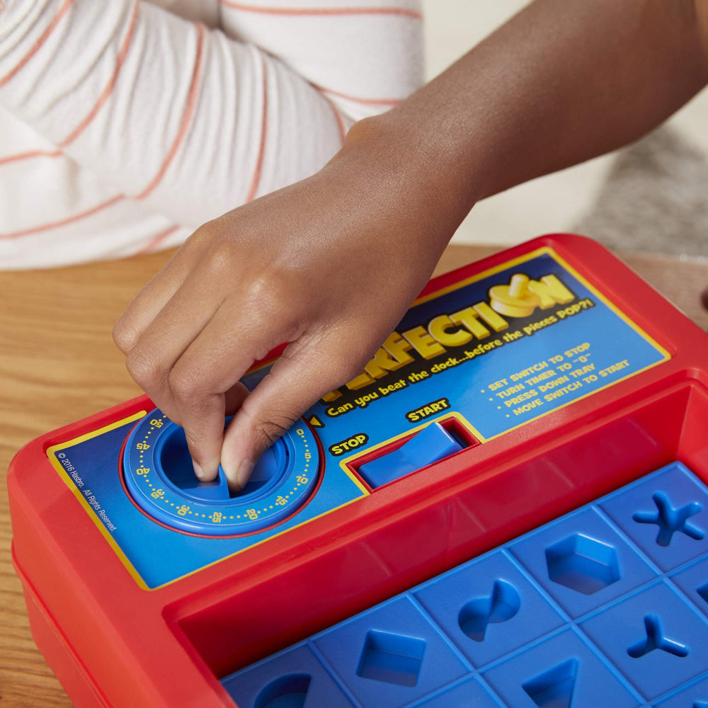 Hasbro Gaming Perfection shape holes inviting quick recognition and placement during play