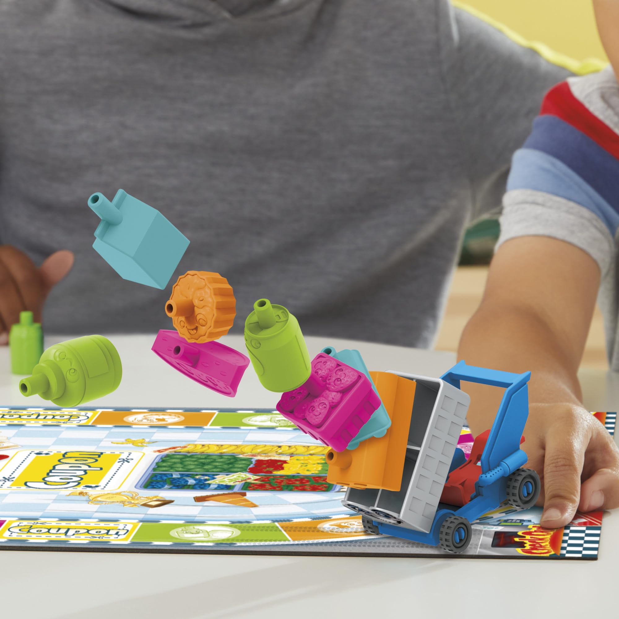 Hasbro Grocery Go Karts dice-roll action, illustrating simple color-matching for young players.