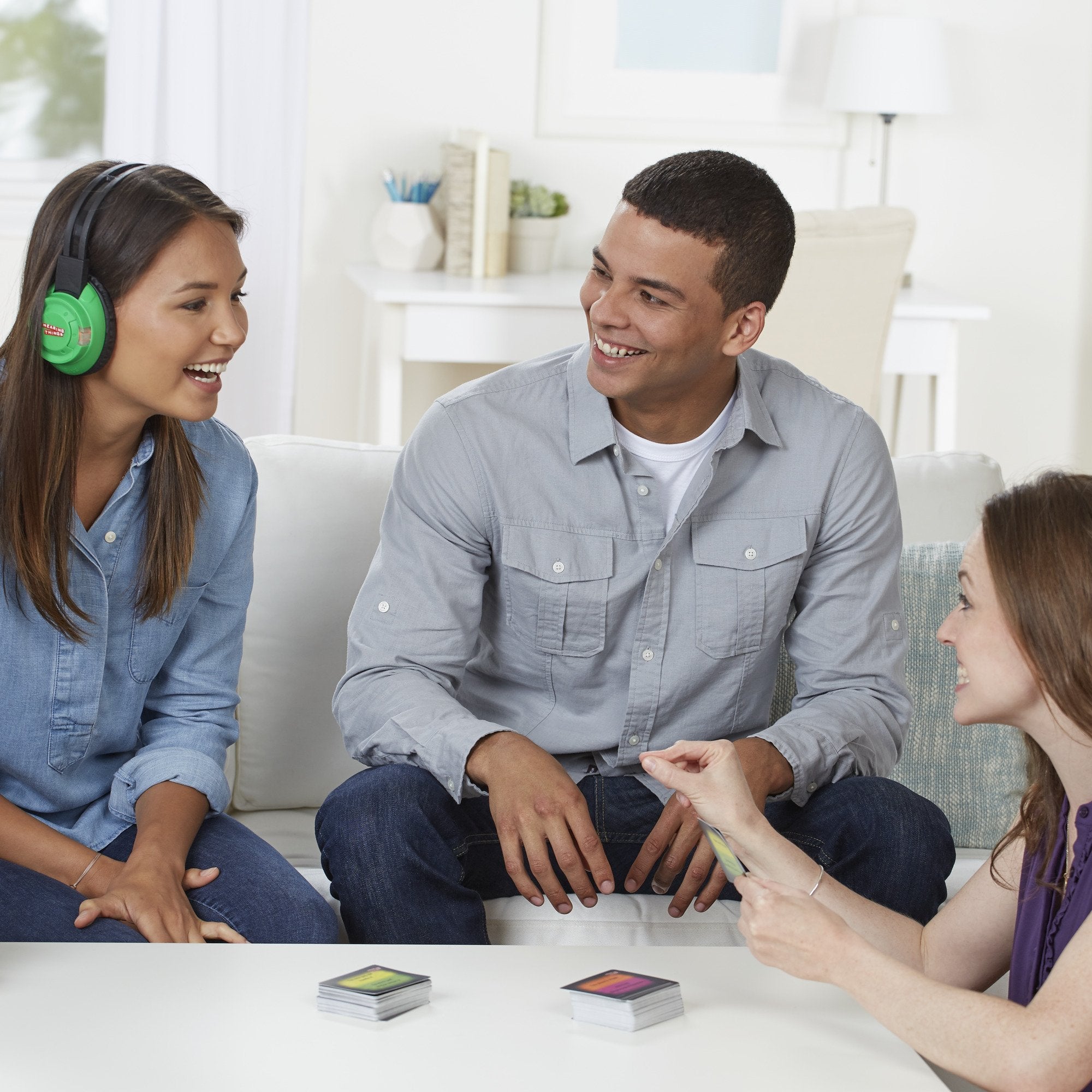 Hasbro Hearing Things game cards displaying 600 phrases for guessing during party play.